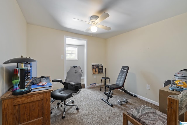 home office featuring baseboards, ceiling fan, and carpet