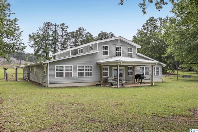 back of house with a lawn and a patio area