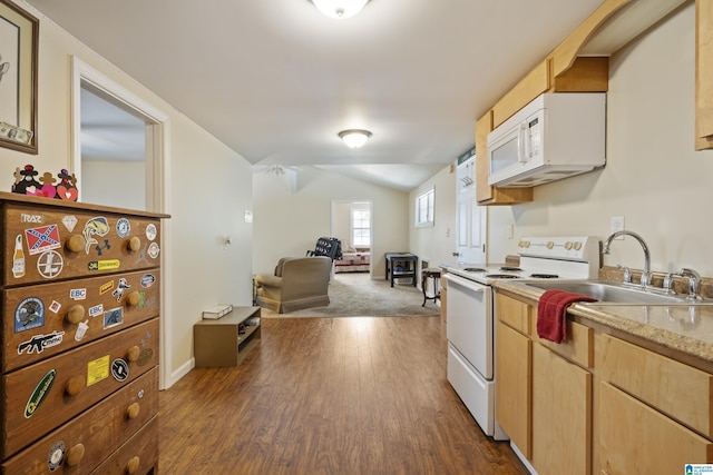 kitchen featuring light countertops, a sink, dark wood-style floors, lofted ceiling, and white appliances