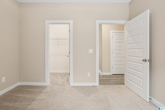 3769 Seaside Sparrow Cir, Bessemer, AL 35022 - unfurnished bedroom featuring a closet, baseboards, carpet flooring, and a walk in closet
