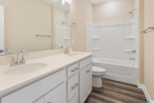 3769 Seaside Sparrow Cir, Bessemer, AL 35022 - bathroom featuring double vanity, a sink, shower / tub combination, and wood finished floors