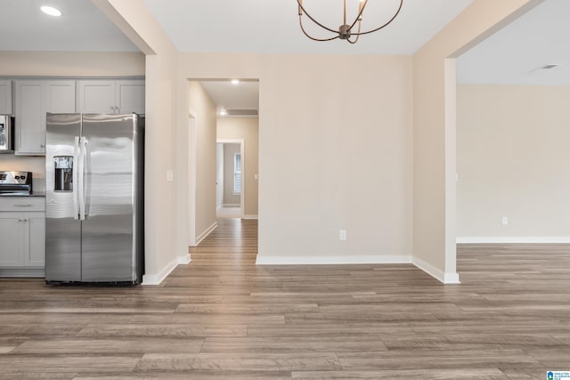 3769 Seaside Sparrow Cir, Bessemer, AL 35022 - interior space featuring light wood-type flooring, an inviting chandelier, appliances with stainless steel finishes, and gray cabinets
