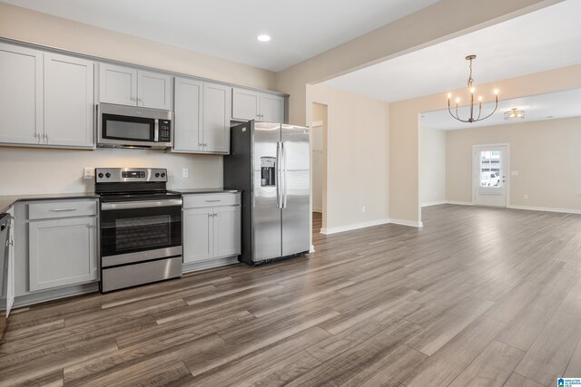 3769 Seaside Sparrow Cir, Bessemer, AL 35022 - kitchen with recessed lighting, wood finished floors, a chandelier, stainless steel appliances, and open floor plan