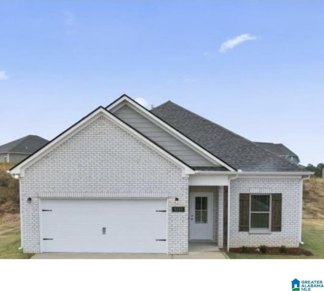 view of front of home with brick siding, driveway, and an attached garage