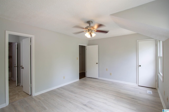 302 Old Rocky Ridge Ln, Birmingham, AL 35216 - unfurnished bedroom featuring baseboards, a textured ceiling, and light wood finished floors