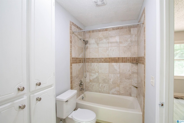 302 Old Rocky Ridge Ln, Birmingham, AL 35216 - bathroom with washtub / shower combination, a textured ceiling, visible vents, and toilet