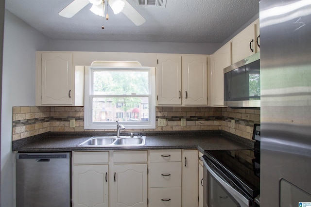 302 Old Rocky Ridge Ln, Birmingham, AL 35216 - kitchen featuring dark countertops, a sink, white cabinets, and stainless steel appliances