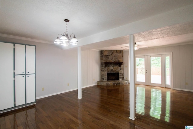 302 Old Rocky Ridge Ln, Birmingham, AL 35216 - unfurnished living room featuring a fireplace, baseboards, a textured ceiling, wood finished floors, and ceiling fan with notable chandelier