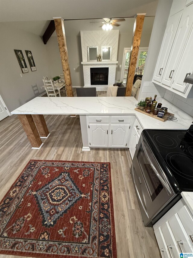 5600 Double Tree Cir, Birmingham, AL 35242 - kitchen with light wood finished floors, a ceiling fan, white cabinetry, a peninsula, and light stone countertops