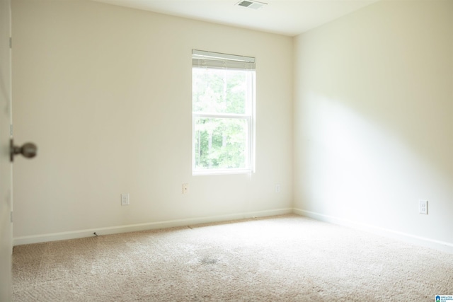 carpeted spare room with baseboards