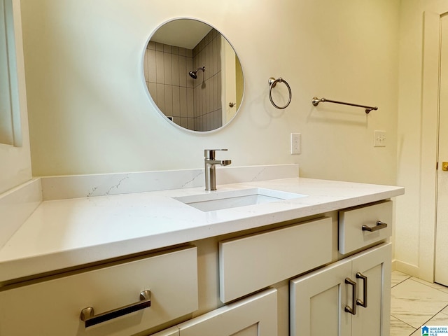 bathroom with marble finish floor and vanity