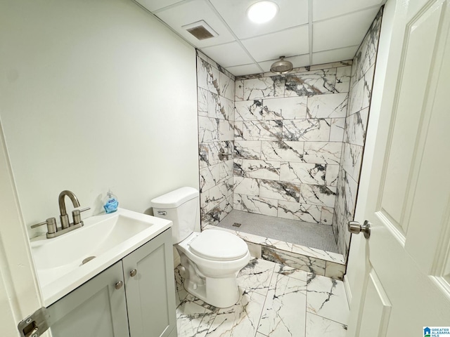 full bath featuring vanity, toilet, marble finish floor, visible vents, and a stall shower