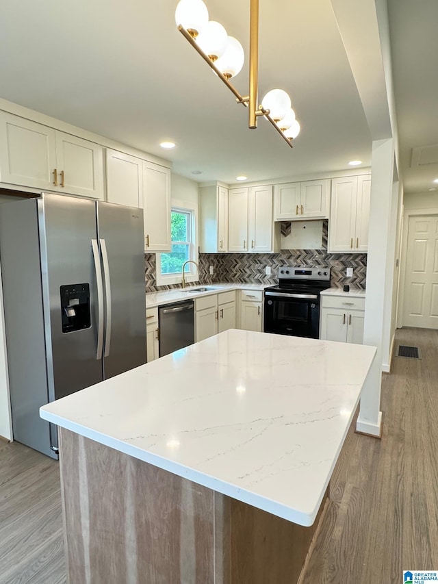 kitchen featuring light wood finished floors, white cabinetry, and stainless steel appliances