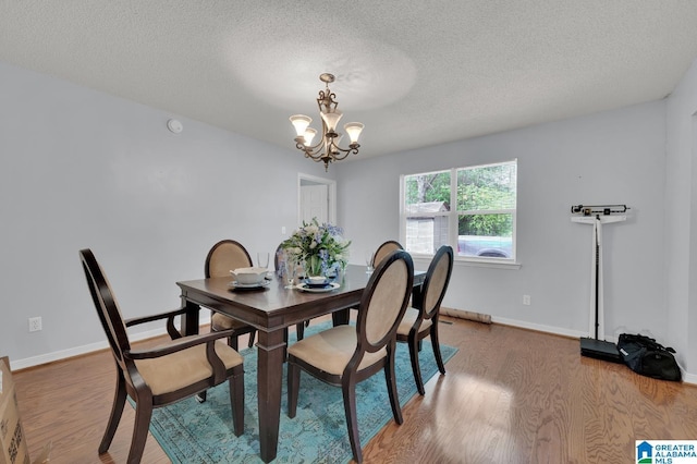 135 Hayden Springs Rd, Hayden, AL 35079 - dining space with a chandelier, wood finished floors, and a textured ceiling