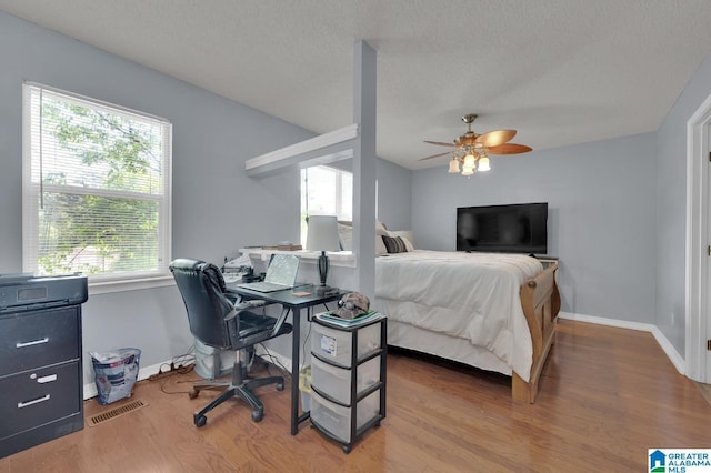 135 Hayden Springs Rd, Hayden, AL 35079 - bedroom with a textured ceiling, ceiling fan, wood finished floors, and baseboards
