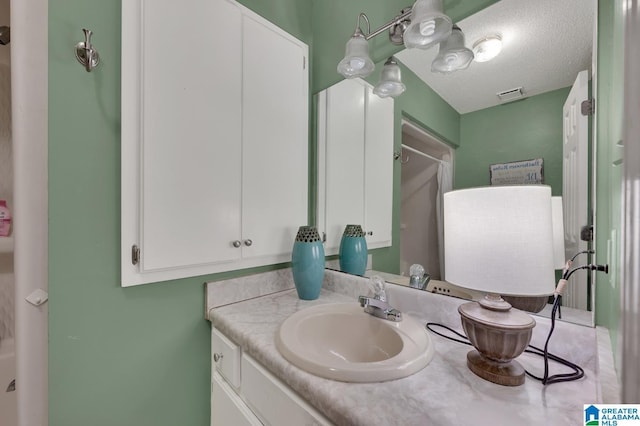 135 Hayden Springs Rd, Hayden, AL 35079 - bathroom featuring visible vents, a textured ceiling, and vanity