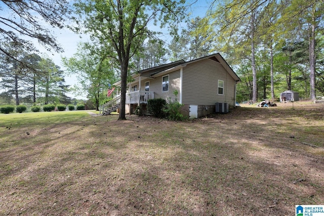 135 Hayden Springs Rd, Hayden, AL 35079 - view of side of property featuring a porch, a lawn, an outdoor structure, and central AC unit