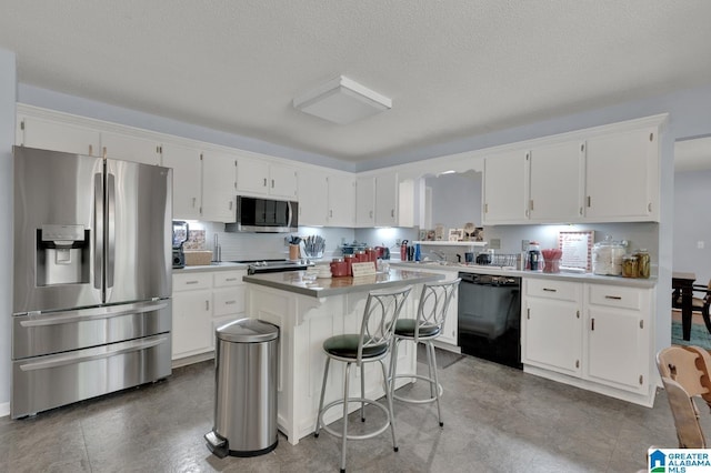 135 Hayden Springs Rd, Hayden, AL 35079 - kitchen with a center island, white cabinetry, and stainless steel appliances