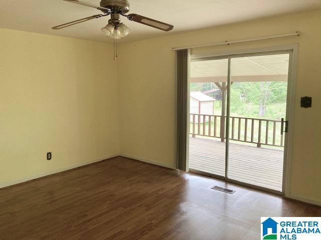 4905 Spunky Hollow Rd, Remlap, AL 35133 - spare room with baseboards, visible vents, wood finished floors, and a ceiling fan