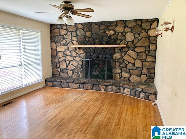 4905 Spunky Hollow Rd, Remlap, AL 35133 - unfurnished living room featuring visible vents, wood finished floors, ceiling fan, and ornamental molding