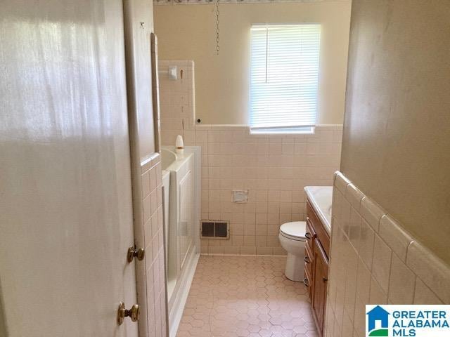 4905 Spunky Hollow Rd, Remlap, AL 35133 - full bathroom featuring tile patterned floors, tile walls, toilet, vanity, and visible vents