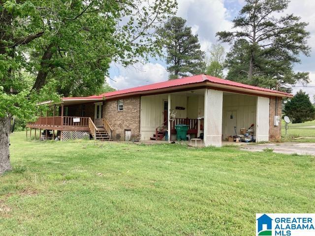 4905 Spunky Hollow Rd, Remlap, AL 35133 - rear view of house featuring a deck, a yard, and brick siding