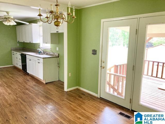 4905 Spunky Hollow Rd, Remlap, AL 35133 - kitchen with visible vents, crown molding, white cabinetry, and ceiling fan with notable chandelier