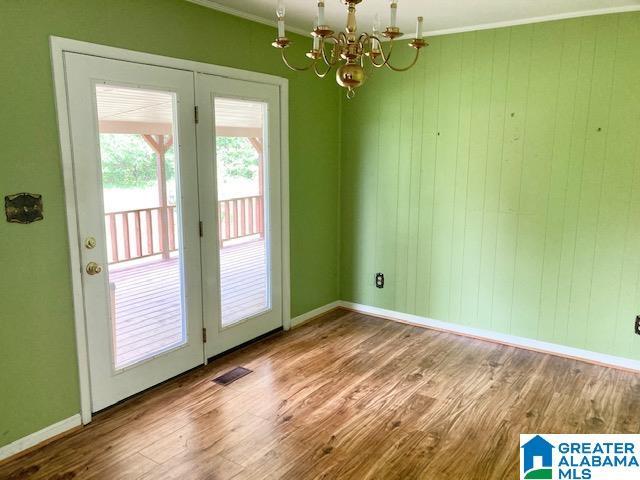 4905 Spunky Hollow Rd, Remlap, AL 35133 - interior space with wood finished floors, baseboards, visible vents, a notable chandelier, and crown molding