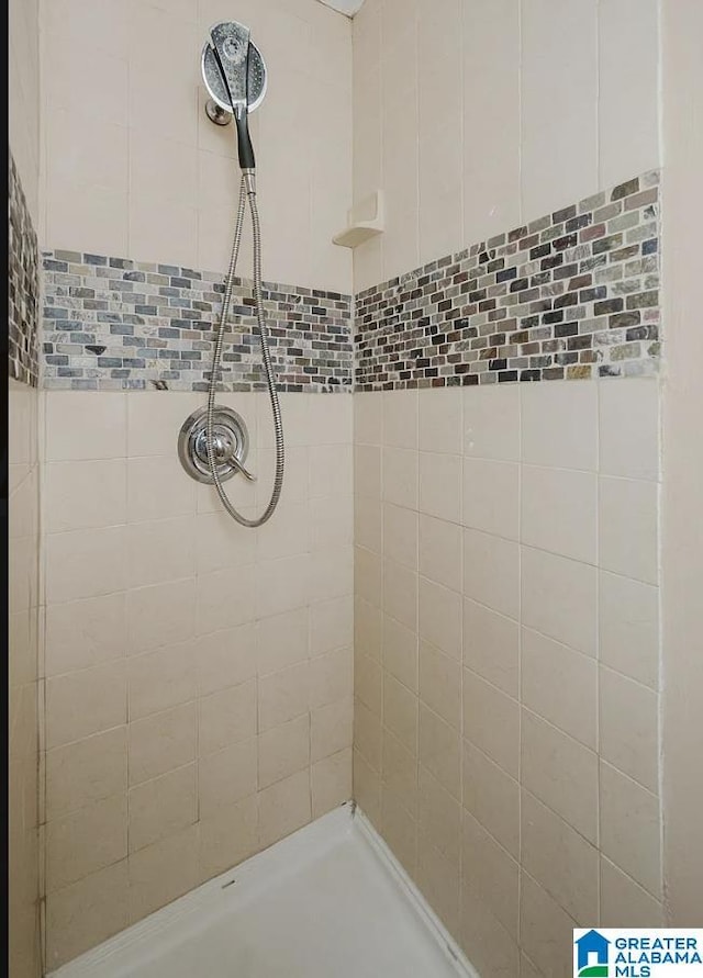 bathroom with tiled shower