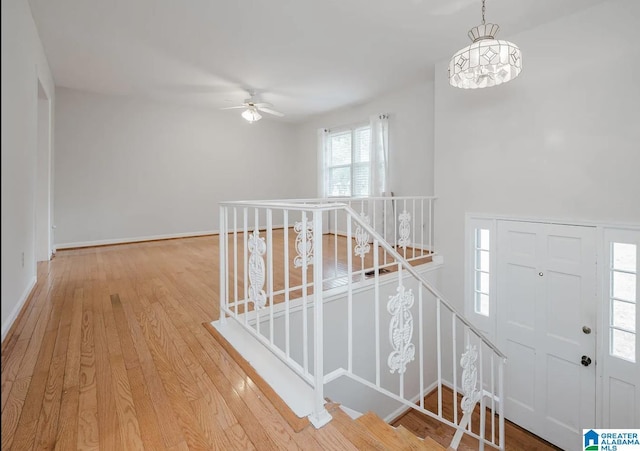 interior space featuring baseboards, wood finished floors, and ceiling fan