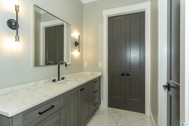 bathroom featuring baseboards, marble finish floor, and vanity