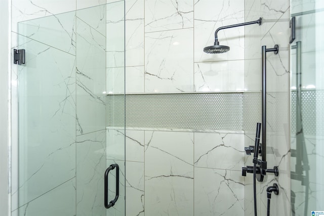 bathroom with a marble finish shower