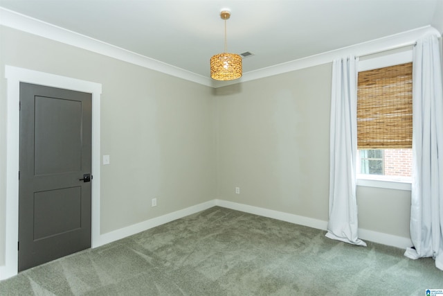 unfurnished room with baseboards, carpet, and crown molding