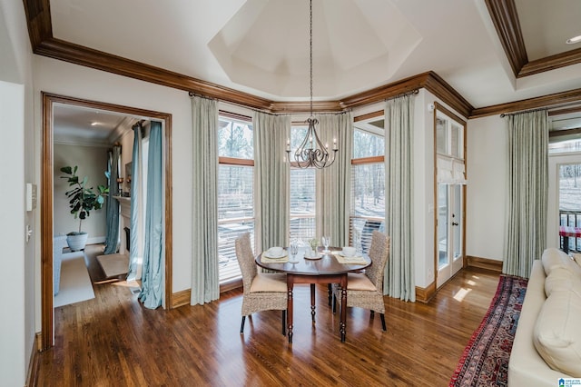 dining room featuring crown molding, baseboards, a notable chandelier, and dark wood finished floors