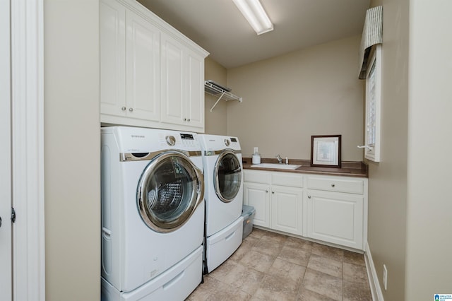 laundry room featuring a sink, cabinet space, and washer and dryer