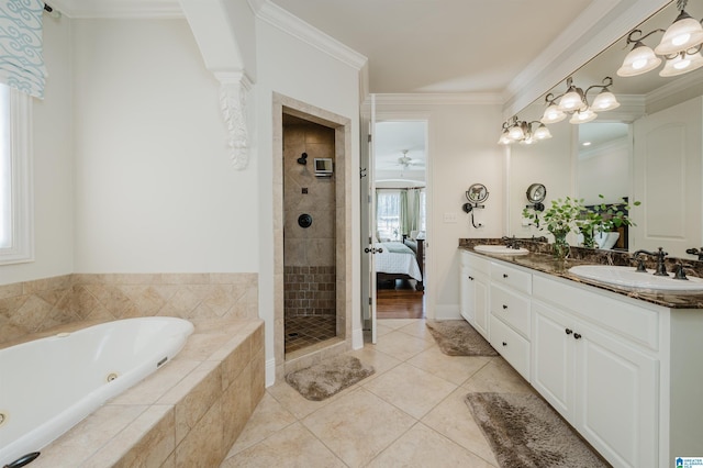 bathroom with a whirlpool tub, a sink, a tile shower, and double vanity