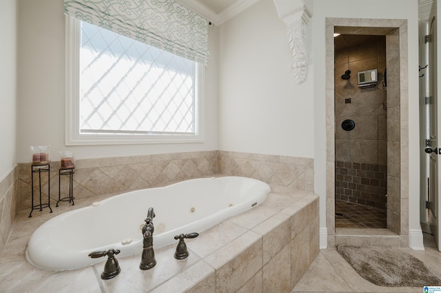 bathroom featuring a whirlpool tub, ornamental molding, and tiled shower