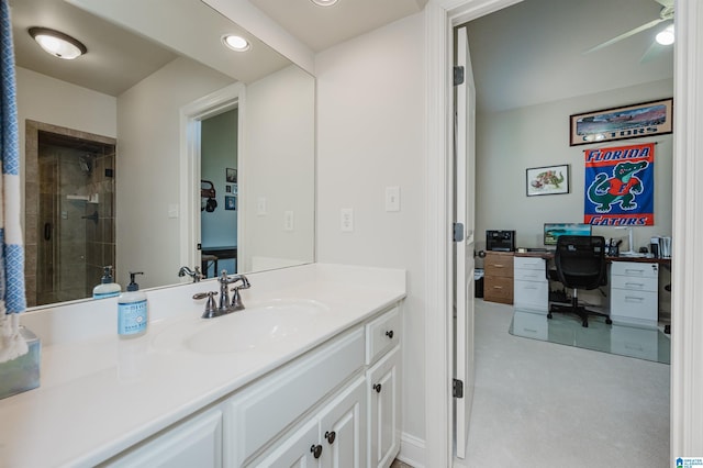 bathroom with recessed lighting, ceiling fan, tiled shower, and vanity