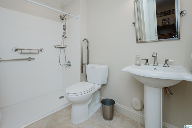 bathroom with tile patterned flooring, baseboards, a shower, and toilet