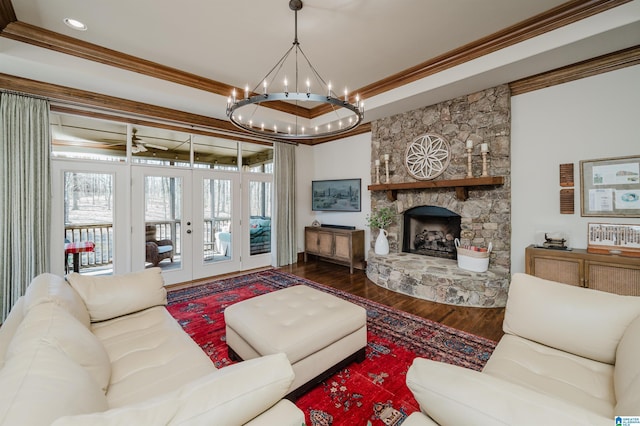 living area featuring ornamental molding, wood finished floors, plenty of natural light, french doors, and a notable chandelier