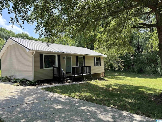 ranch-style house with a porch, metal roof, and a front lawn