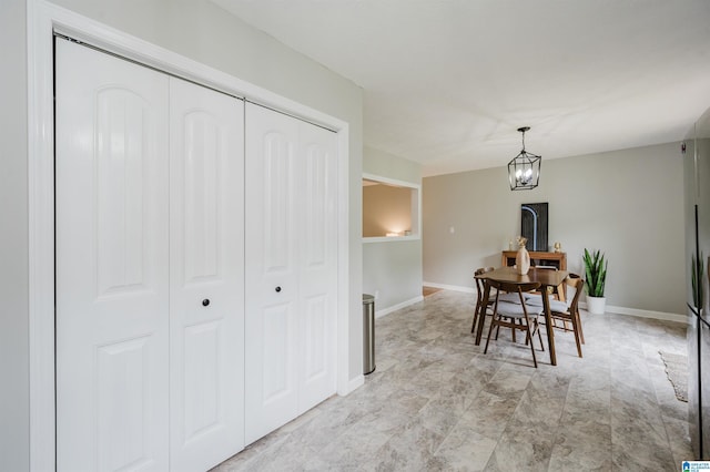 dining room featuring baseboards and a chandelier