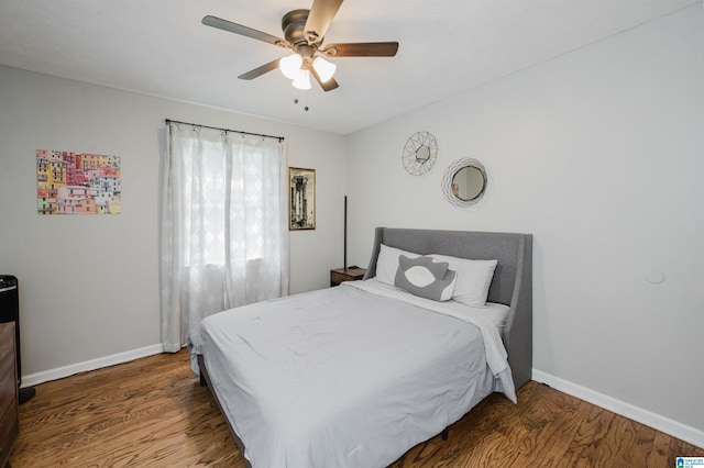 bedroom featuring baseboards, a ceiling fan, and wood finished floors