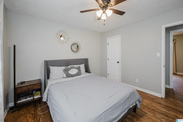 bedroom featuring a ceiling fan, baseboards, and wood finished floors