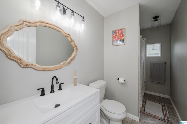 bathroom with baseboards, vanity, toilet, and curtained shower