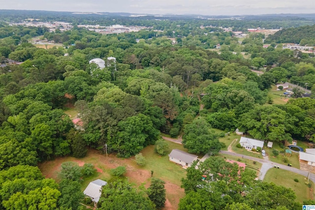 birds eye view of property with a view of trees