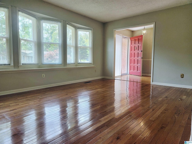 574 Turtle Creek Dr, Hoover, AL 35226 - empty room with hardwood / wood-style floors, baseboards, a textured ceiling, and a chandelier