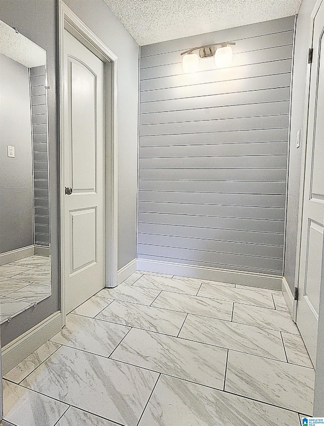 574 Turtle Creek Dr, Hoover, AL 35226 - hallway featuring light marble finish floors, a textured ceiling, and baseboards