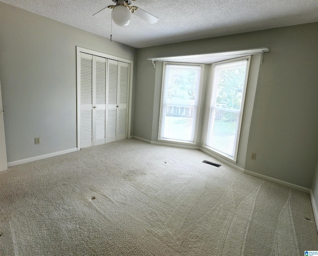 574 Turtle Creek Dr, Hoover, AL 35226 - unfurnished bedroom featuring carpet flooring, a textured ceiling, a closet, baseboards, and a ceiling fan