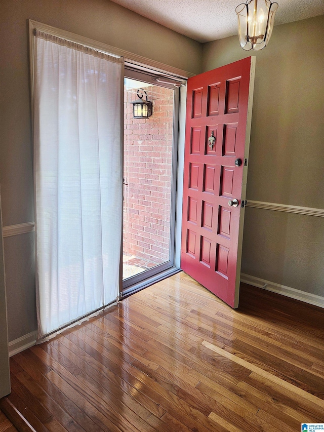 574 Turtle Creek Dr, Hoover, AL 35226 - entrance foyer with wood finished floors, a chandelier, baseboards, and a textured ceiling
